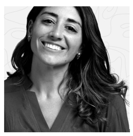 Black and white photo of a woman with long hair smiling, wearing a blouse and earrings. Abstract background.