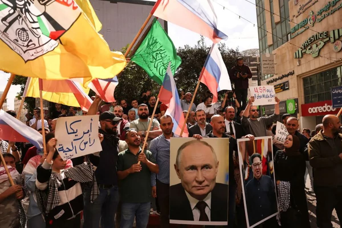 A protest with waving of Russian flags and posters of Vladimir Putin of the North Korean leader.