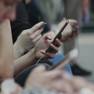 A group of people on the subway texting on their phones